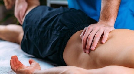 Massage therapy session at Mobility and Massage, Huddersfield, England, GB showing hands applying pressure on a back.