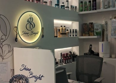 Reception area of Shine Bright Ladies Salon in Abu Dhabi showcasing stylish decor and beauty products.