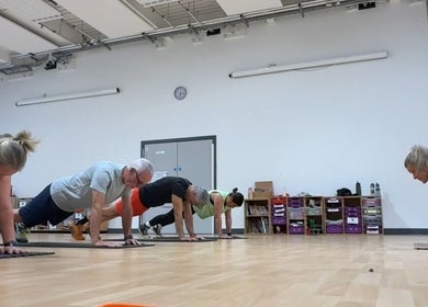 Group fitness session at MK Training in Holyport, England, GB, featuring participants in plank positions.