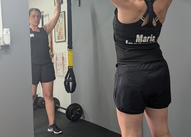 Individual working out at MK Training, Holyport, England, GB, using gym equipment in a focused setting.