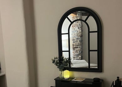 Elegant mirror at Skin & Glo, Macclesfield, England, GB reflects soothing spa ambiance.