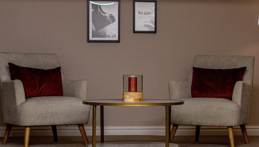 Inviting lounge area at Skin & Glo, Macclesfield, England with comfy chairs and modern decor.