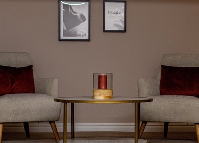 Inviting lounge area at Skin & Glo, Macclesfield, England with comfy chairs and modern decor.