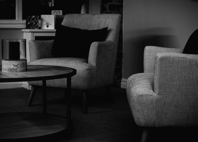 Elegant seating area at Skin & Glo, Macclesfield, England, GB, featuring plush chairs and wooden coffee table.