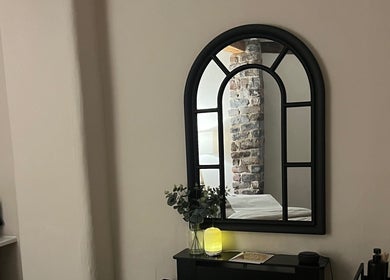 Cozy treatment room mirror at Skin & Glo, Macclesfield, England, GB, reflecting a serene and inviting space.