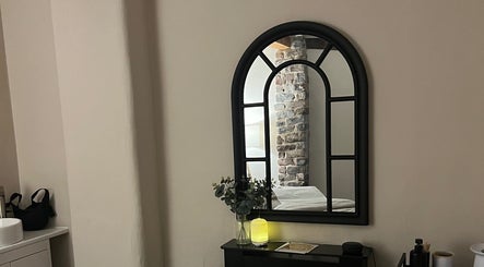 Cozy treatment room mirror at Skin & Glo, Macclesfield, England, GB, reflecting a serene and inviting space.