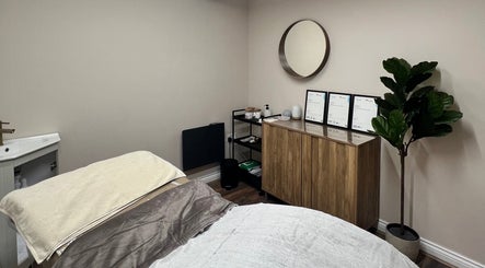 Calming treatment room at Skin & Glo, Macclesfield, England, GB, featuring soothing decor and a comfortable bed.