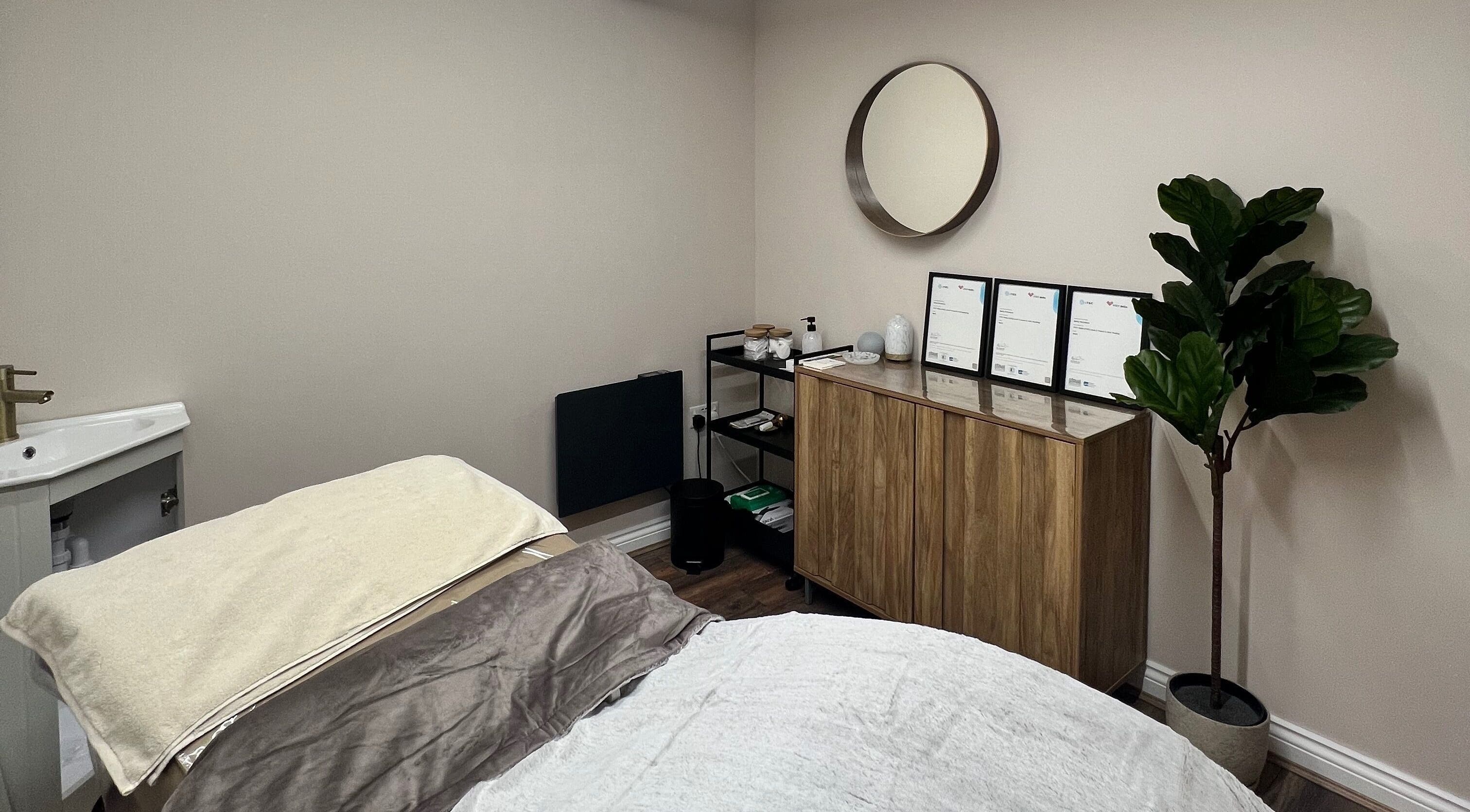 Relaxing therapy room at Skin & Glo, Macclesfield, England, GB, featuring cozy bed and minimalistic decor.