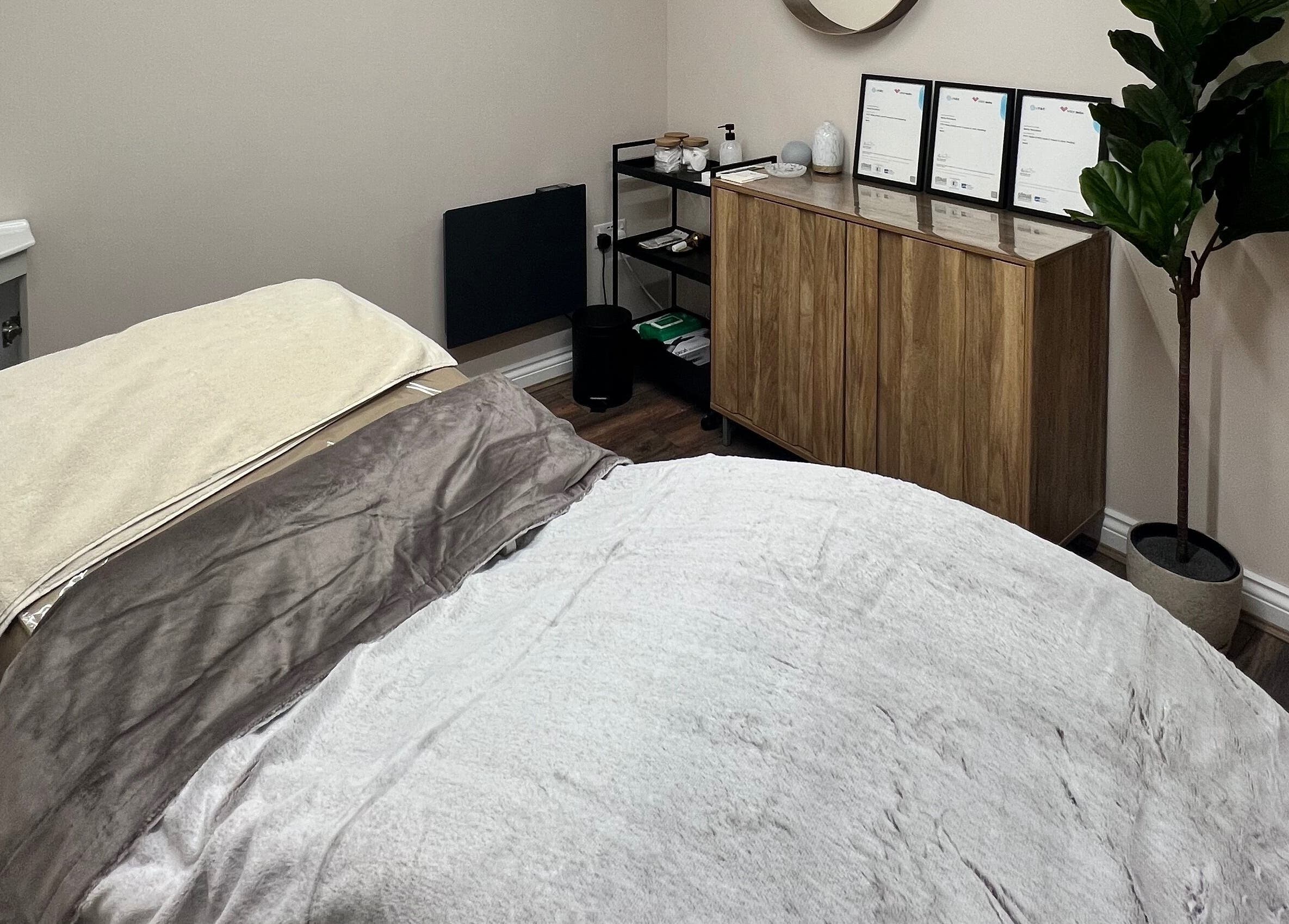 Cozy spa treatment room at Skin & Glo, Macclesfield, England, GB. Features soft lighting and elegant decor.