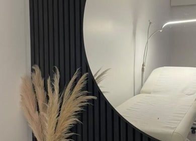 Calming treatment room at Beauty HQ, Southport, England, GB featuring a modern massage table and elegant decor.