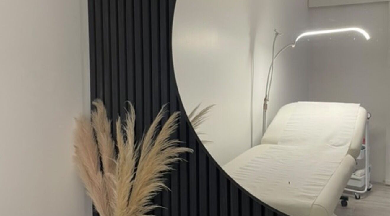 Calming treatment room at Beauty HQ, Southport, England, GB featuring a modern massage table and elegant decor.