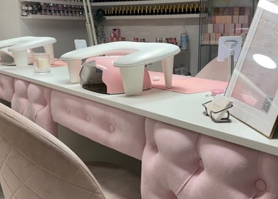 Chic nail station at Beauty HQ in Southport, England, GB featuring plush pink decor and manicure setups.