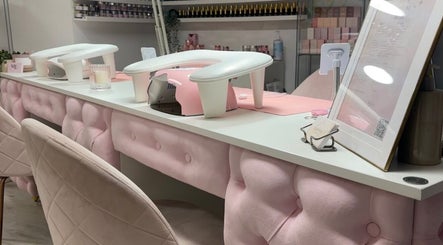 Chic nail station at Beauty HQ in Southport, England, GB featuring plush pink decor and manicure setups.