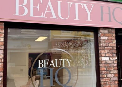 Front entrance of Beauty HQ in Southport, England, GB, showcasing elegant signage on a brick facade.