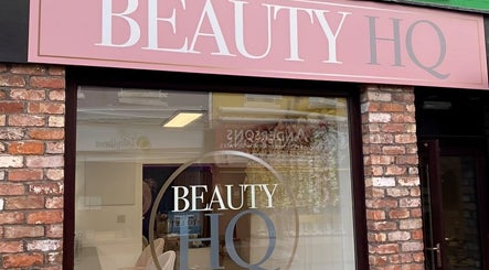Front entrance of Beauty HQ in Southport, England, GB, showcasing elegant signage on a brick facade.