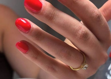 Hand with vibrant red nails at Beauty HQ, Southport, England, GB showcasing elegance and style.