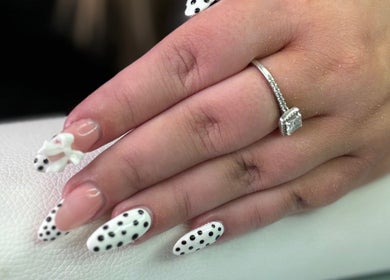 Stylish polka dot nails with a ring on display at Polished Pearl, Bungay, England, GB.