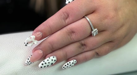 Stylish polka dot nails with a ring on display at Polished Pearl, Bungay, England, GB.