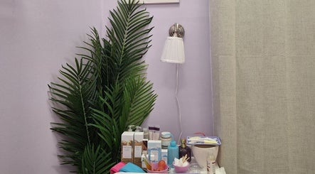 Relaxing spa setup at Massage Facial By Sasha Viki, Glasgow, Scotland, GB with skincare products and greenery.