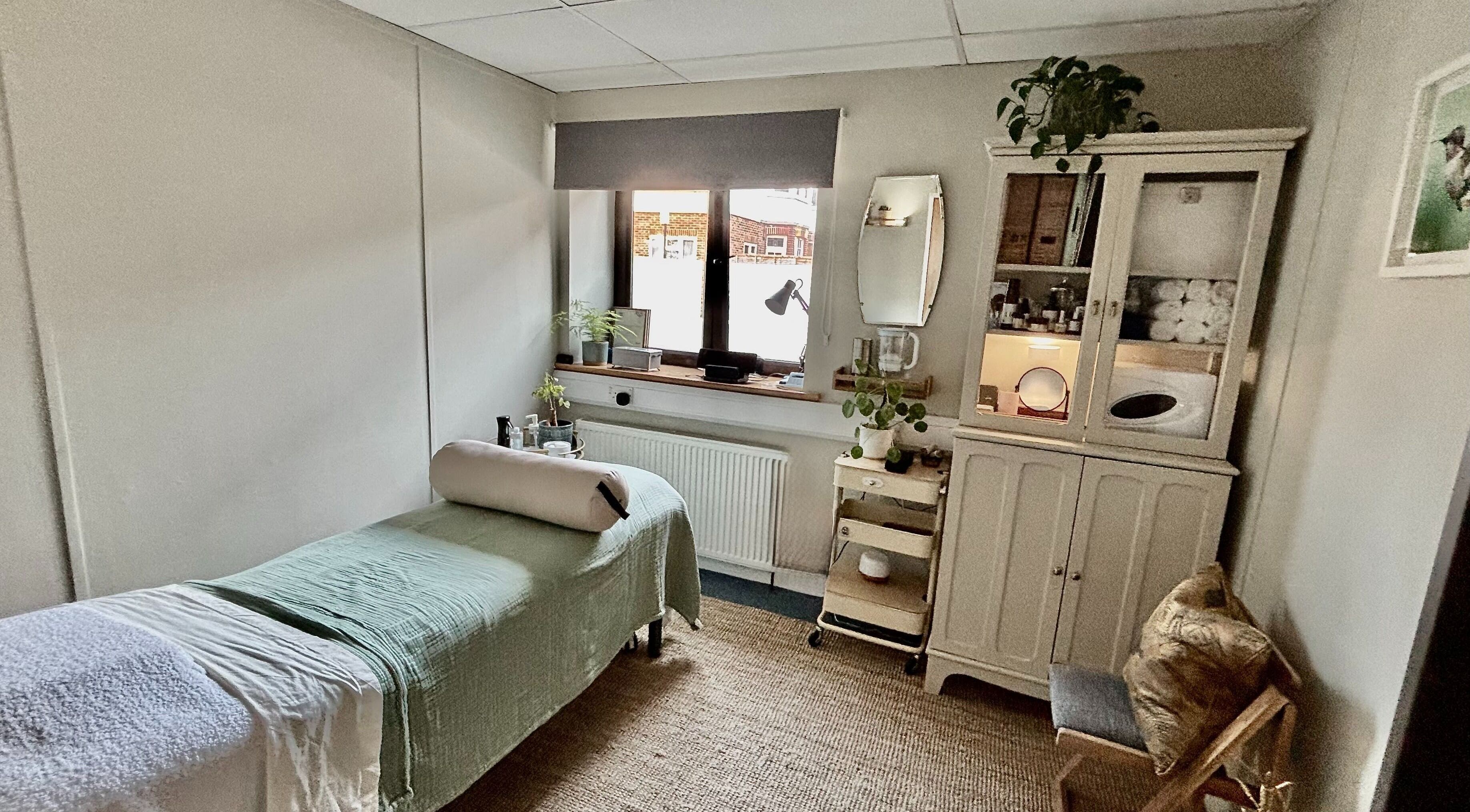 Relaxing massage room at Burning Sage Reflexology, Brighton & Hove, England, GB, featuring soothing decor.