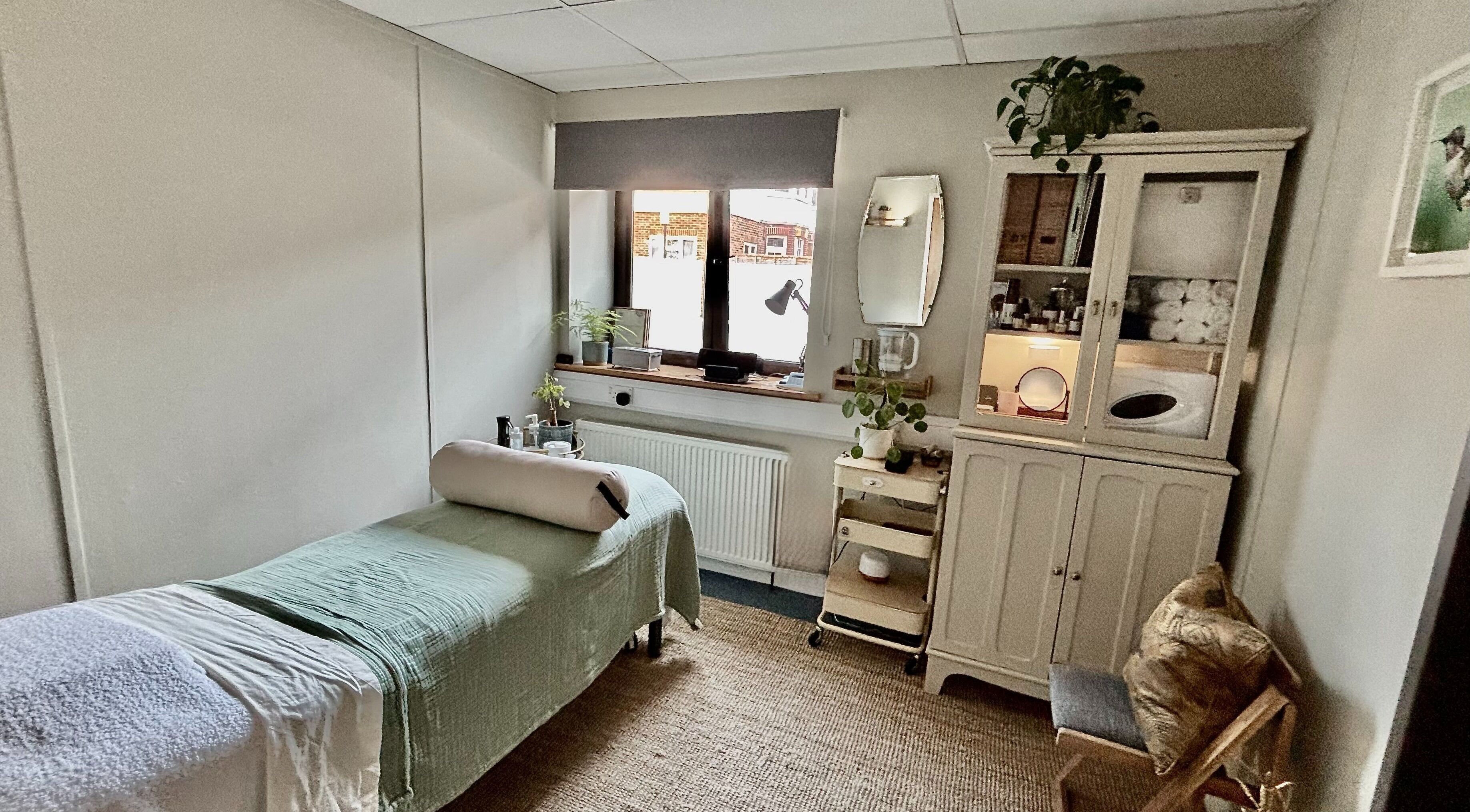 Relaxing massage room at Burning Sage Reflexology, Brighton & Hove, England, GB, featuring soothing decor.