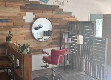 Cozy salon space at Tracey Jack Hair at Evolve, Newquay, England, GB with rustic decor and styling chair.
