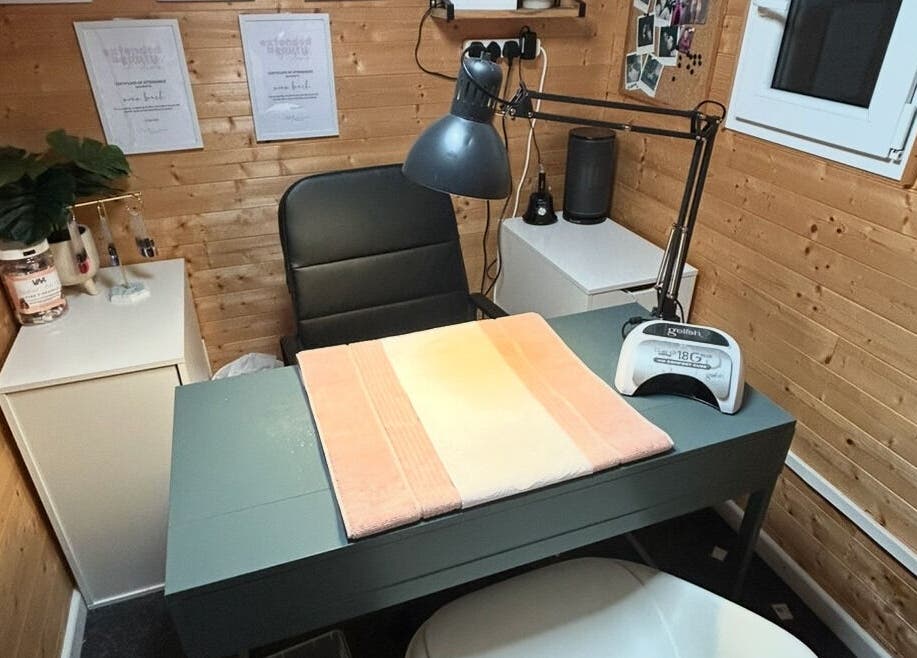 Cozy and inviting nail station at Nailed By Nina, Shirley, England, GB, with modern decor and tools.