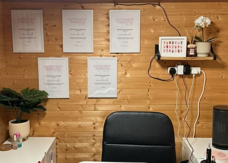 Chic interior of Nailed By Nina in Shirley, England, GB showcasing awards, decor, and workspace essentials.