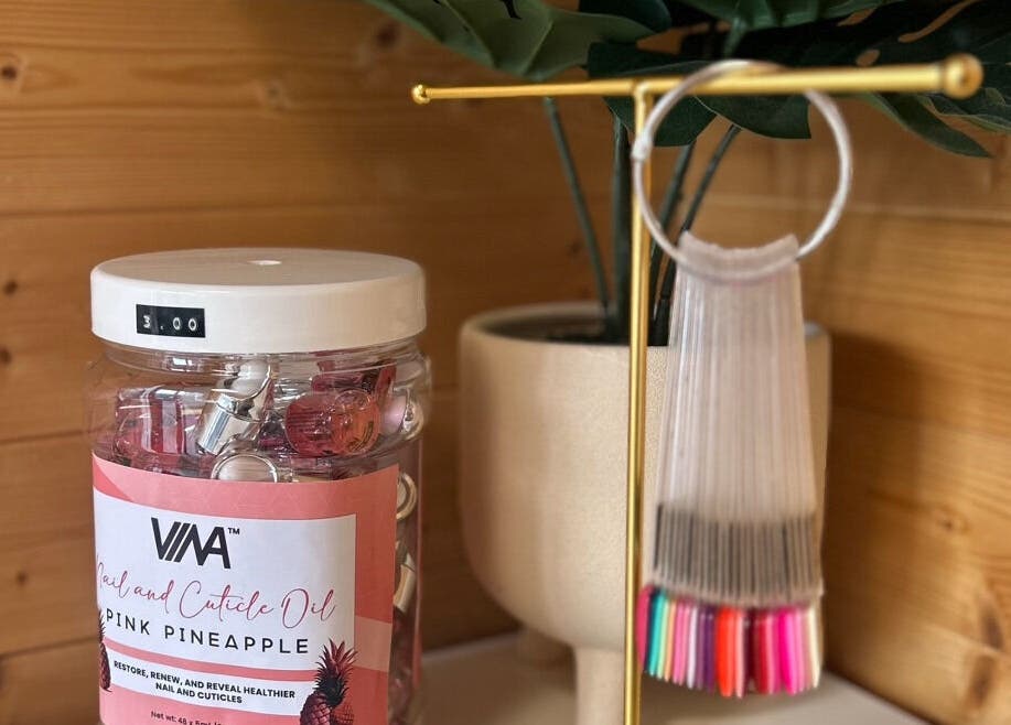 Nailed By Nina in Shirley, England, GB showcases pink pineapple cuticle oil in a relaxing setting.