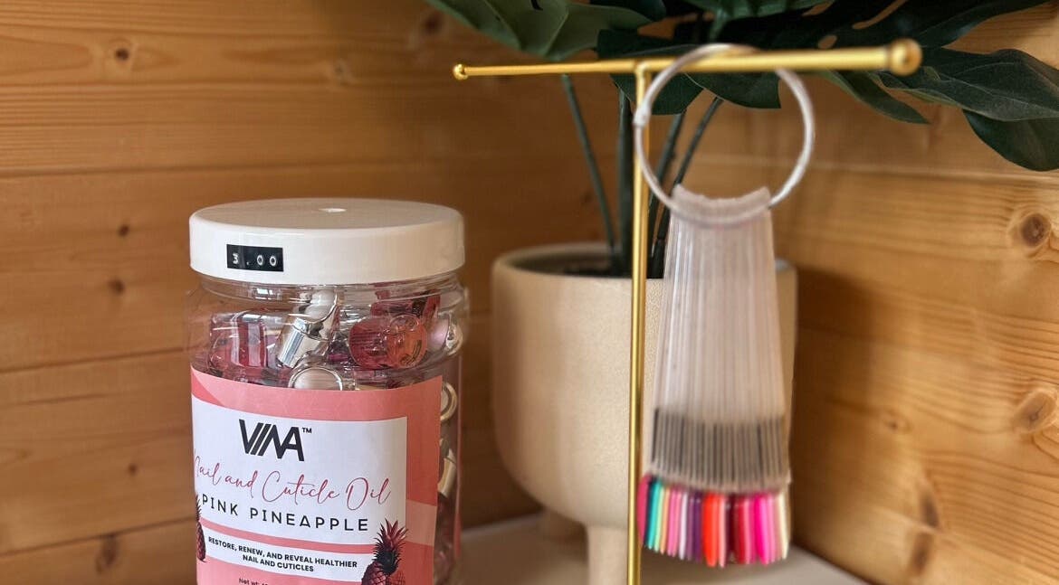 Nailed By Nina in Shirley, England, GB showcases pink pineapple cuticle oil in a relaxing setting.