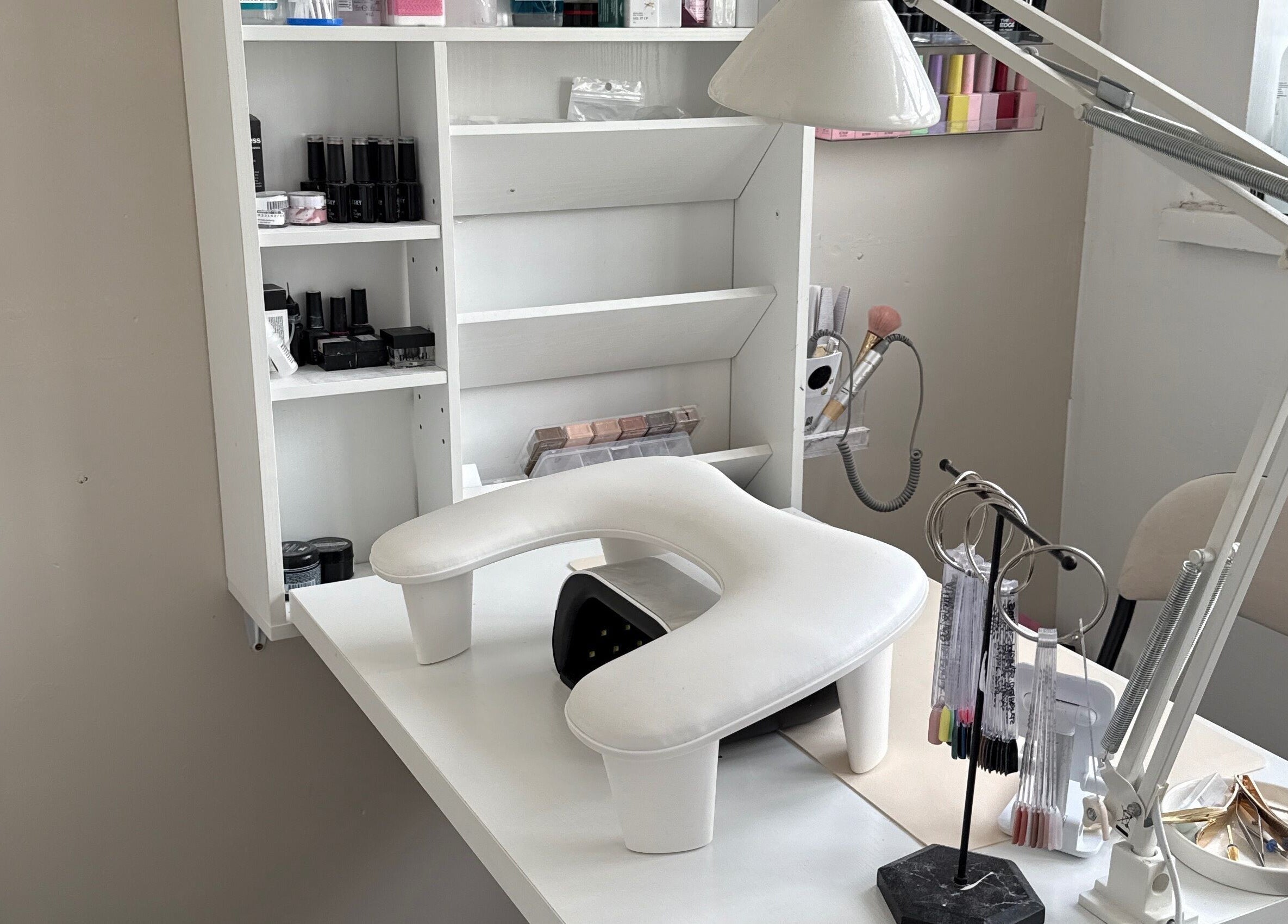 Bright nail salon workspace at Gels By Ells, Bilston, England, GB, showcasing elegant manicure tools and products.