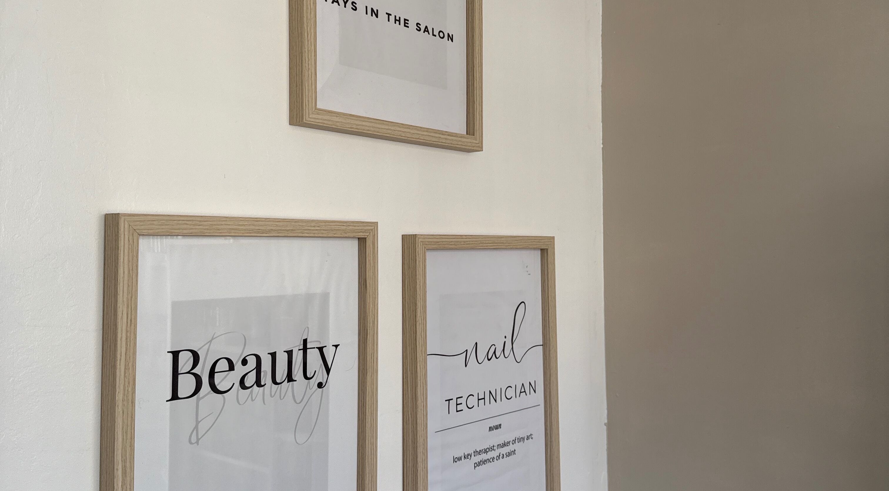 Framed beauty-themed posters in Gels By Ells, Bilston, England, GB salon.