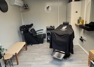 Interior of The Barber Chair By Michael in Wainscott, England, GB featuring sleek barber chair and modern decor.