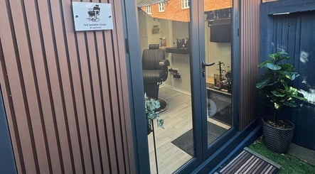 Entrance to The Barber Chair By Michael in Wainscott, England, GB showcasing sleek modern design.