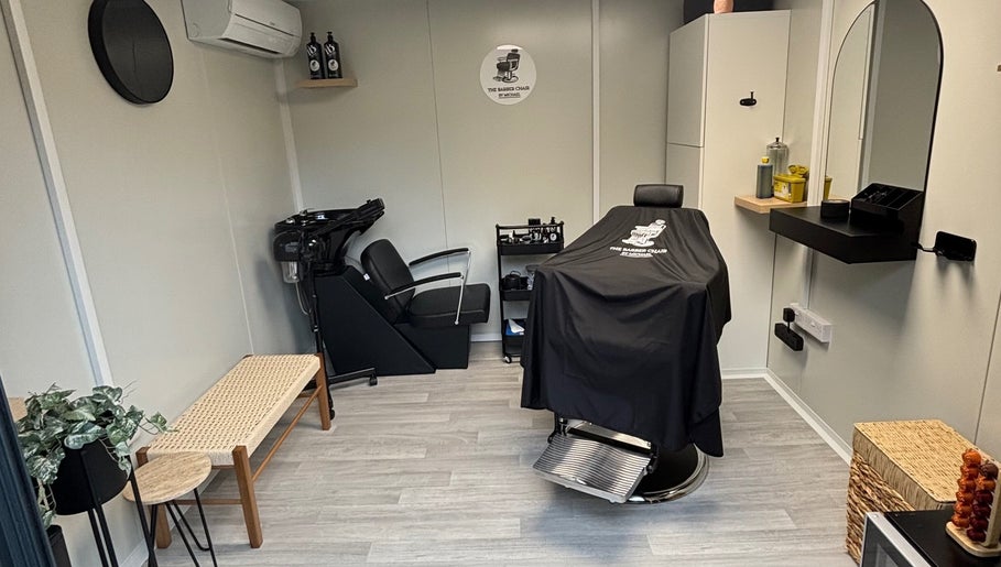 Cozy interior of The Barber Chair By Michael in Wainscott, England, GB, featuring a modern barber chair and wash station.