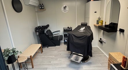 Cozy interior of The Barber Chair By Michael in Wainscott, England, GB, featuring a modern barber chair and wash station.
