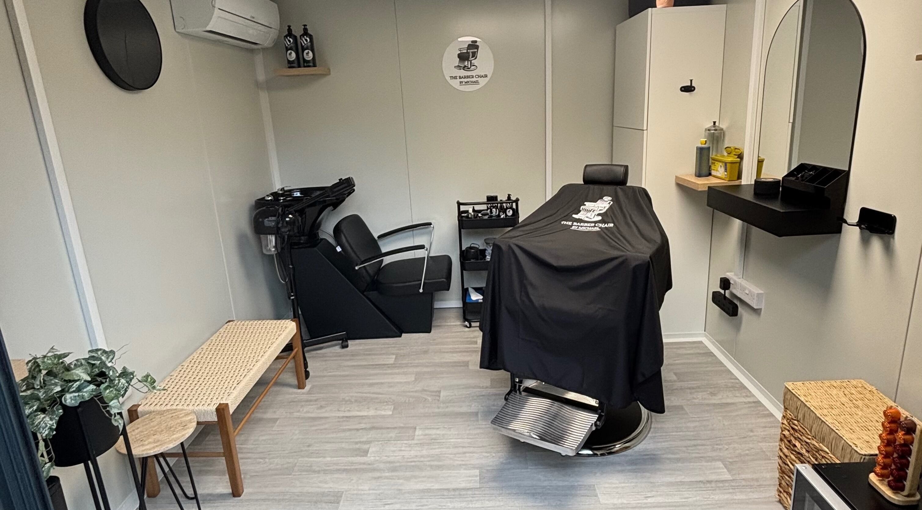 Interior of The Barber Chair By Michael, a chic barbershop in Wainscott, England, GB with modern decor.