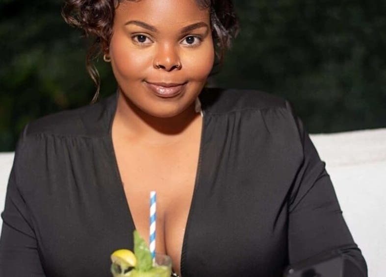 Woman enjoying a refreshing drink at Flawless Finish by Tashii, Kingston, St. Andrew Parish, JM.