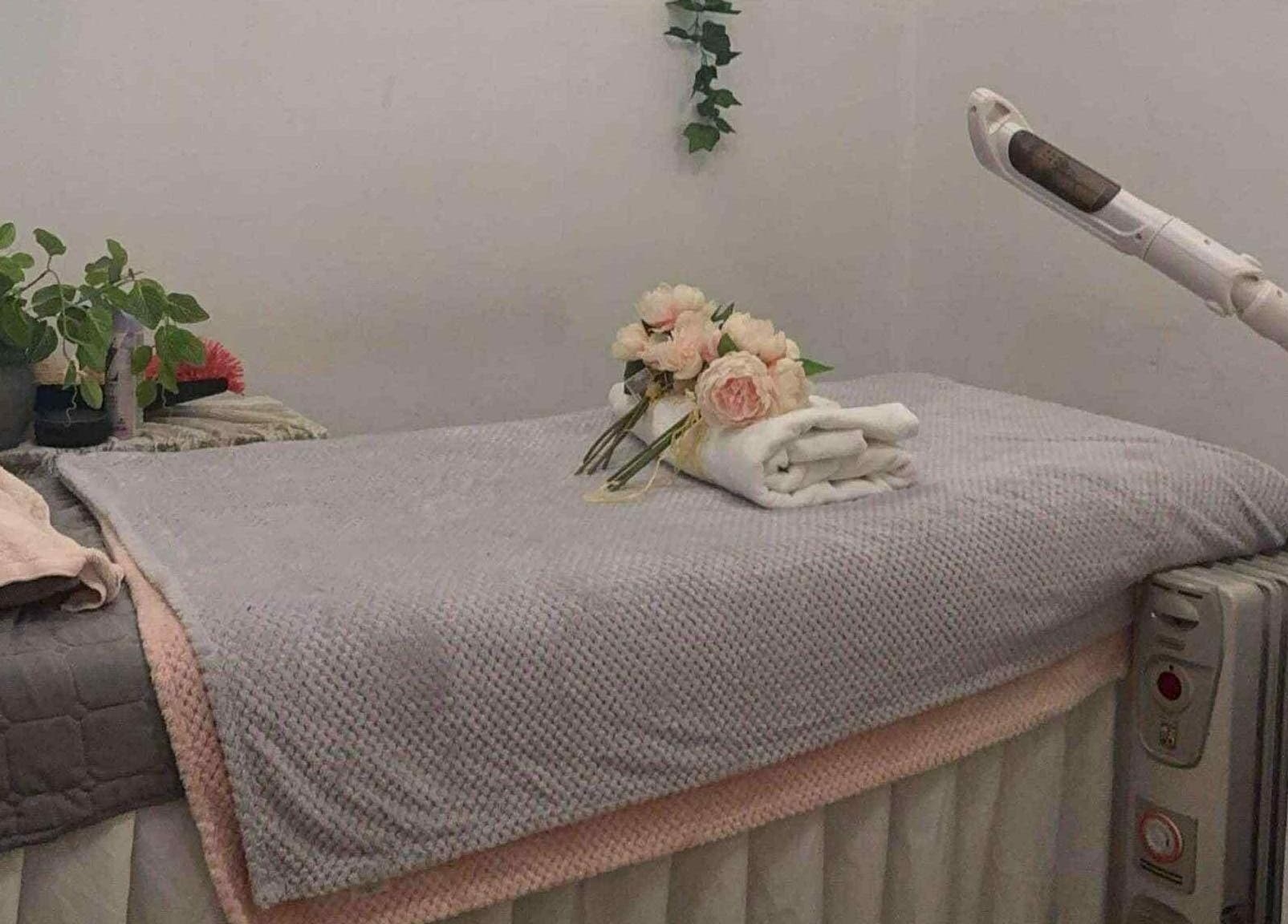 Calming VBeauty Dickson massage room in Dickson, Australian Capital Territory, AU with flowers and plants.