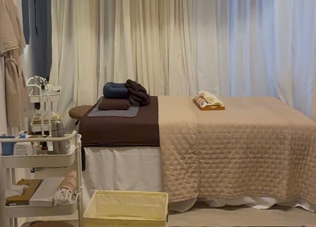 Relaxing treatment room at Luminee Spa in Bali, Bali, ID featuring a plush massage table and calming decor.