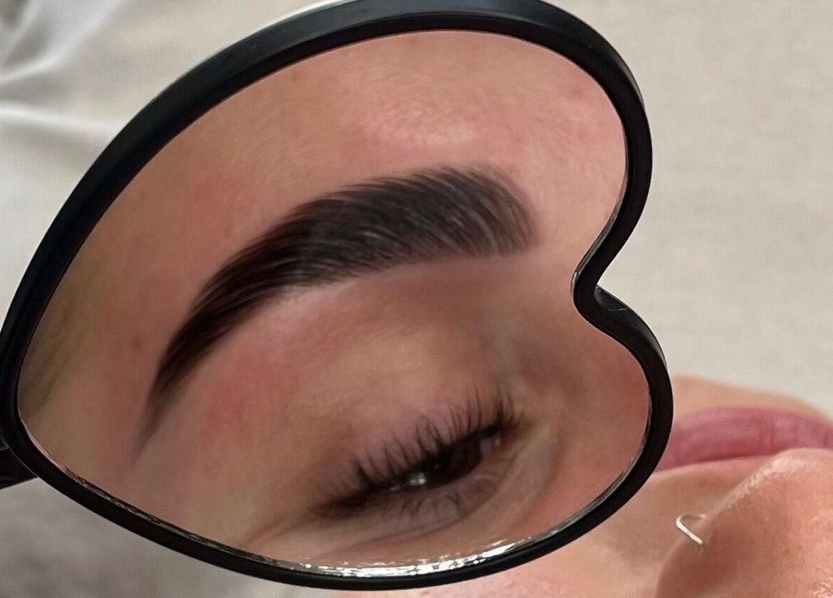 Eyebrow in heart-shaped mirror at Left & Right Beauty, Colchester, England, GB