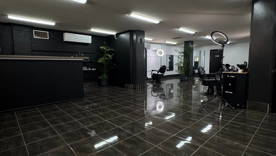 Modern interior of Collective Vision Barbers in Gladstone Central, Queensland, AU, featuring stylish chairs and decor.