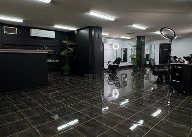 Modern interior of Collective Vision Barbers in Gladstone Central, Queensland, AU, featuring stylish chairs and decor.