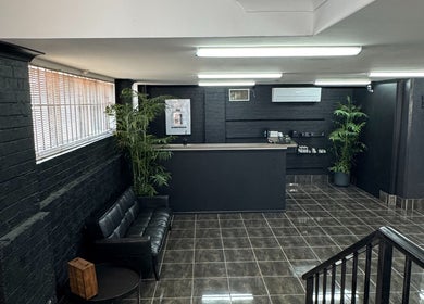 Reception and waiting area at Collective Vision Barbers in Gladstone Central, Queensland, AU, featuring modern decor.
