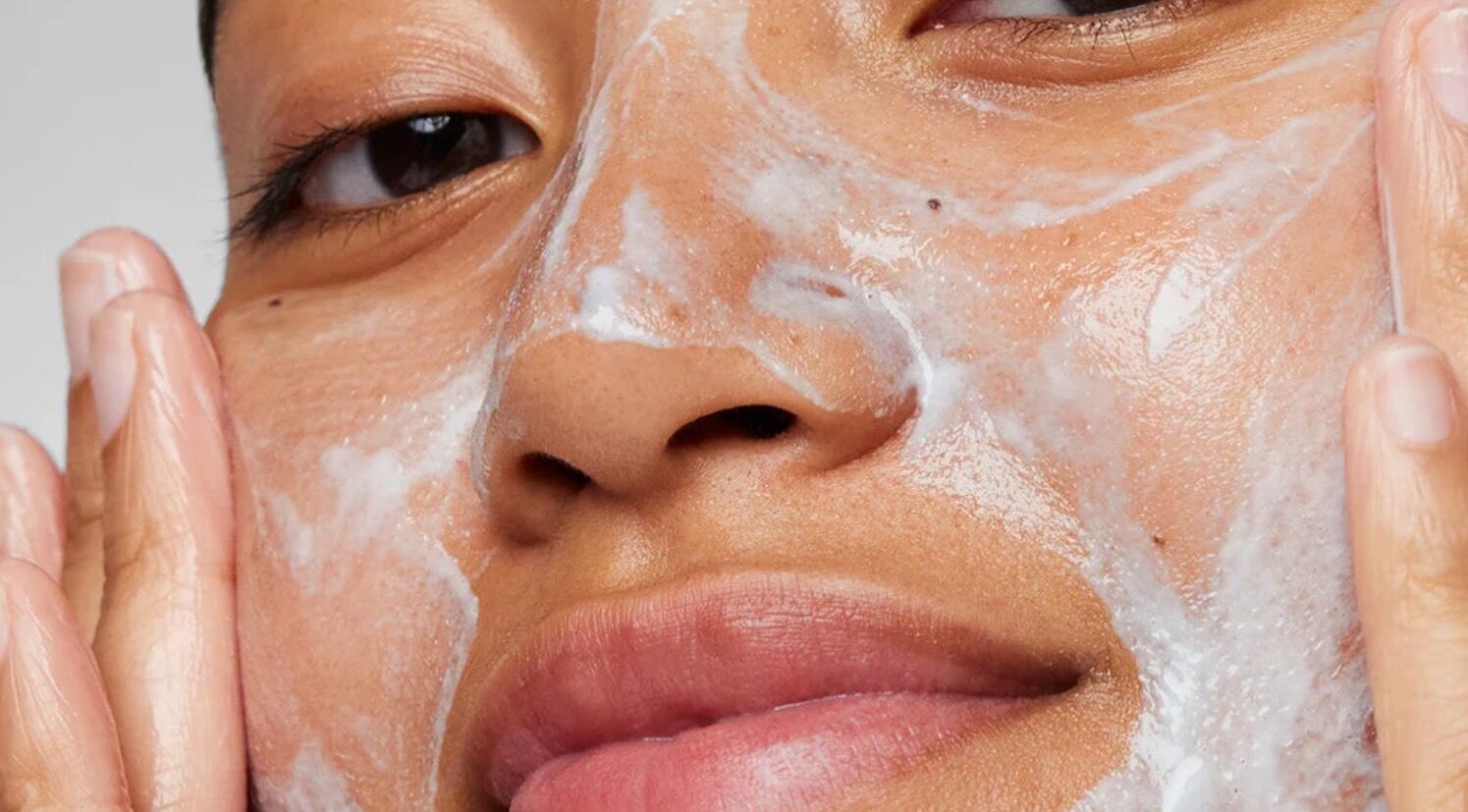 Close-up of a woman applying face cleanser at Cortz Skin Therapy in New York, New York, US.