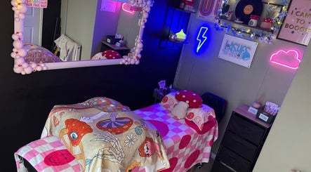 Vibrant treatment room at Lashes By Amy.D in Runcorn, England, GB with neon signs and colorful decor.