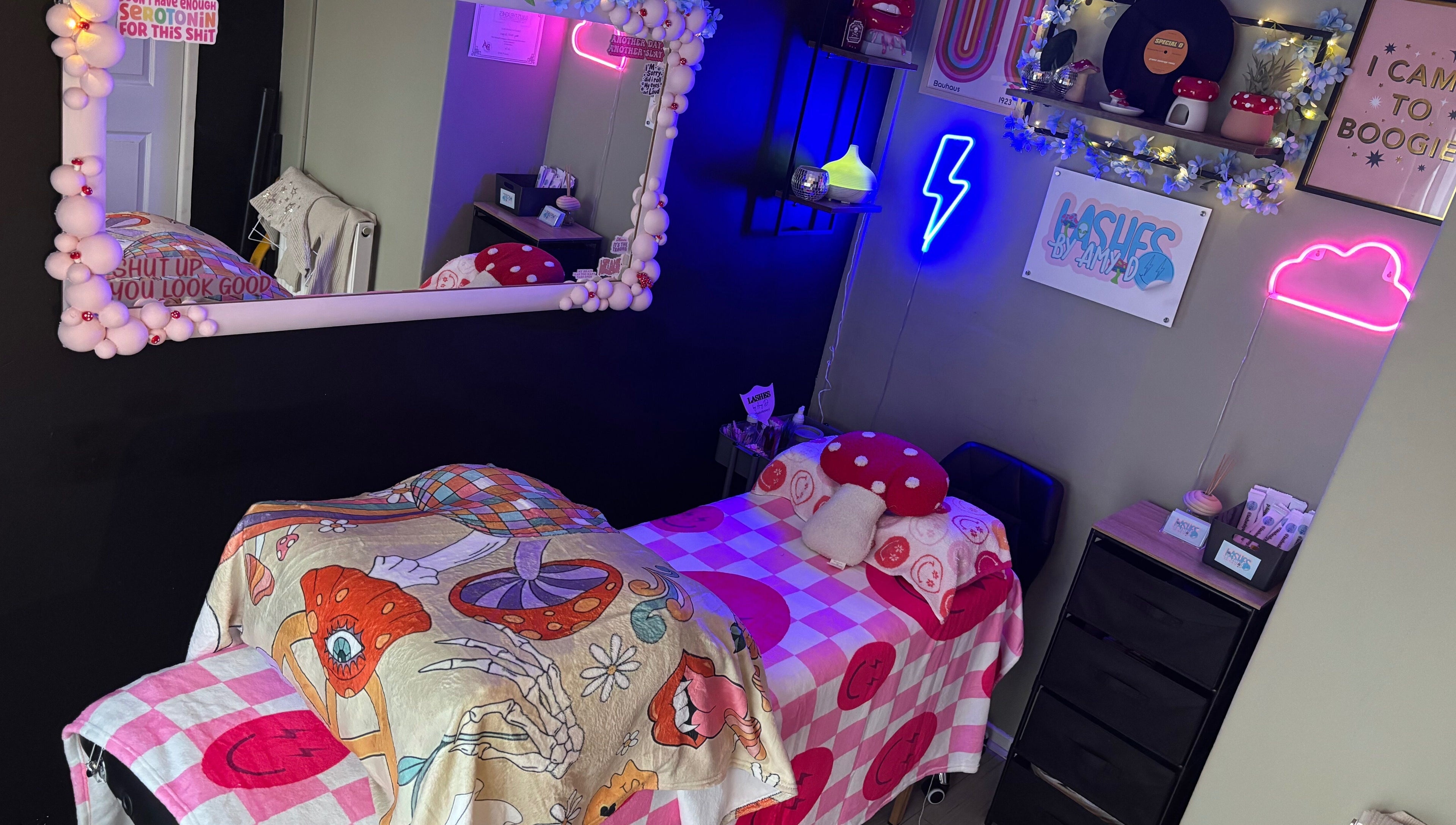 Vivid and cozy beauty room at Lashes By Amy.D in Runcorn, England, GB, featuring neon decor and stylish bedding.