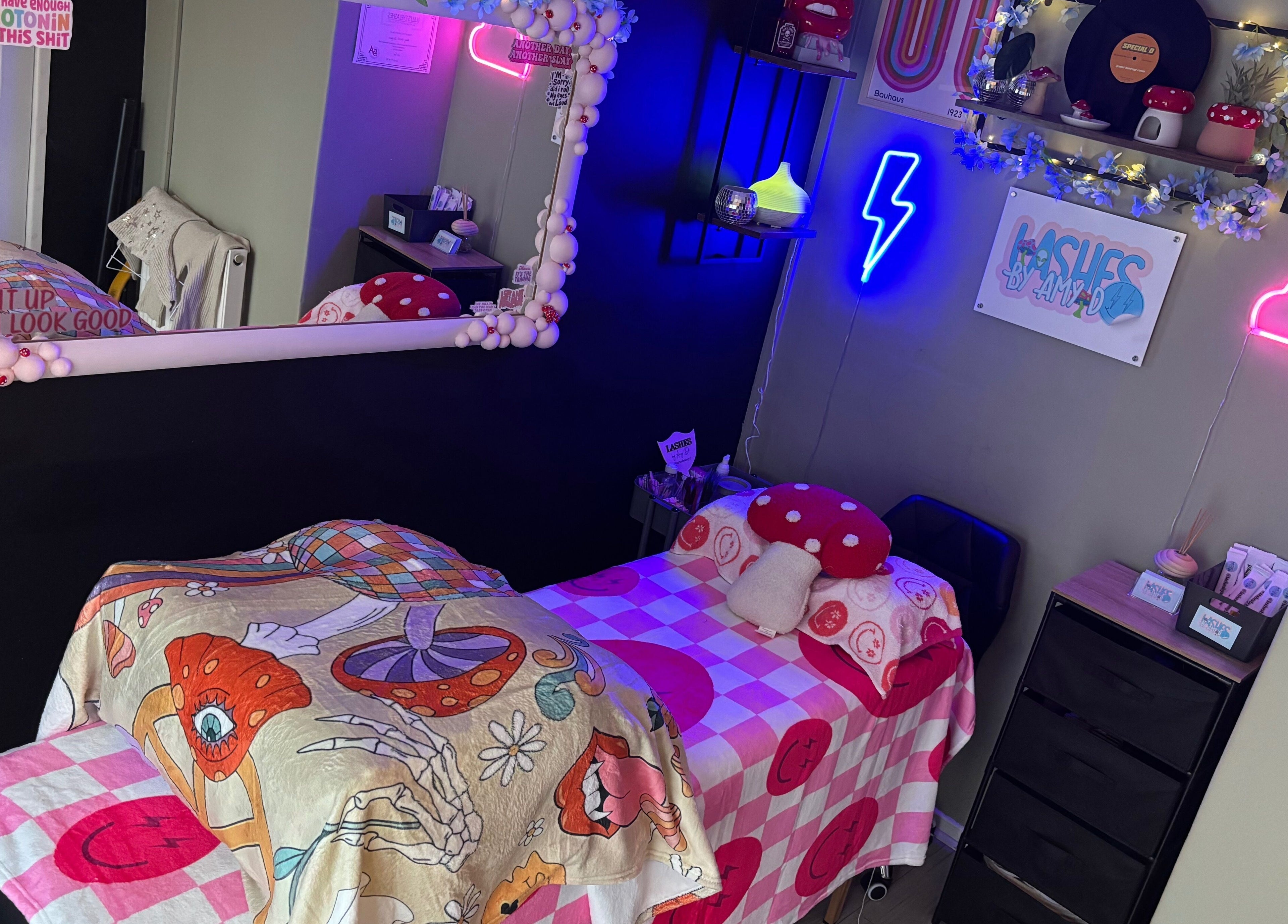 Vivid and cozy beauty room at Lashes By Amy.D in Runcorn, England, GB, featuring neon decor and stylish bedding.