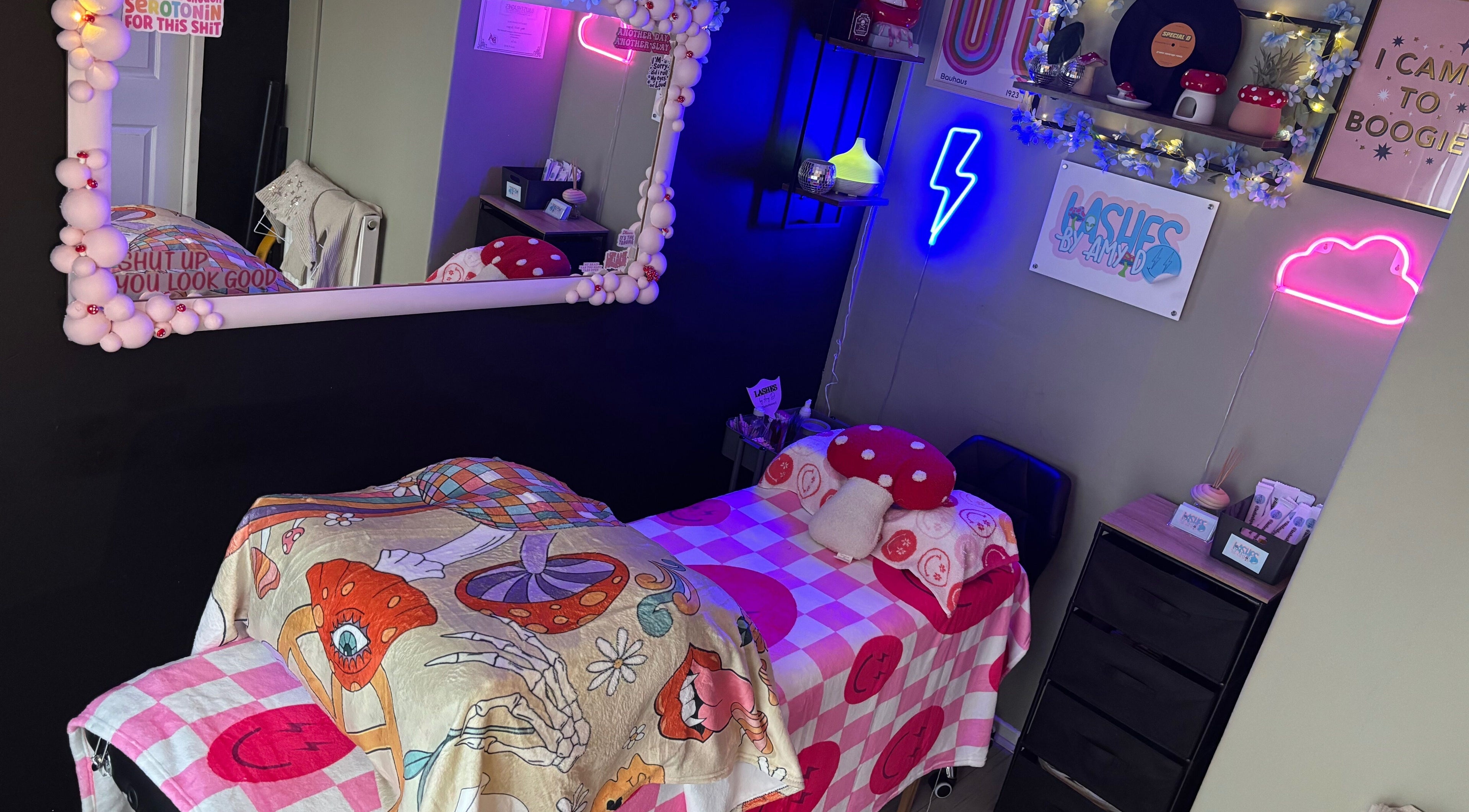 Vivid and cozy beauty room at Lashes By Amy.D in Runcorn, England, GB, featuring neon decor and stylish bedding.