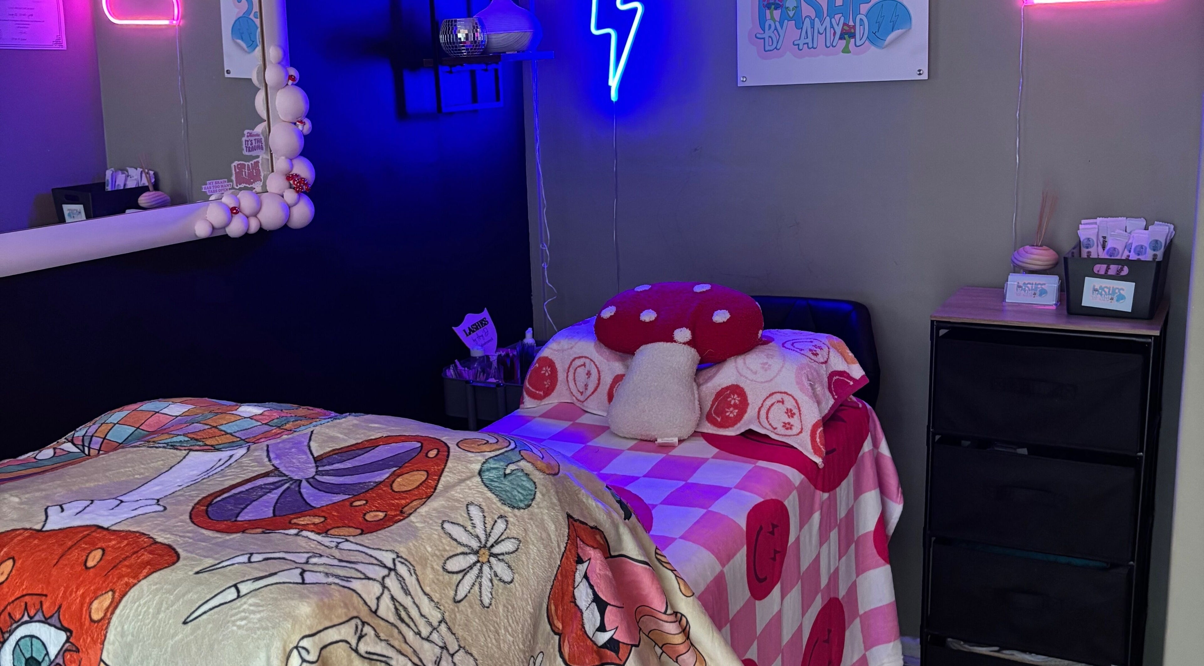 Inviting treatment room at Lashes By Amy.D in Runcorn, England, GB with vibrant decor and neon lights.